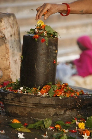 Worshiping Shiva Lingam with Bilva leaves